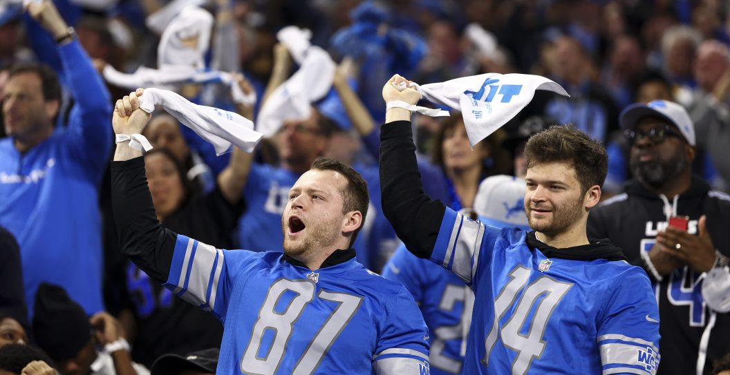 DETROIT, MI - JANUARY 21: Detroit Lions fans cheer and swing towels in the air during the third quarter of an NFL divisional round playoff football game against the Tampa Bay Buccaneers at Ford Field on January 21, 2024 in Detroit, Michigan.