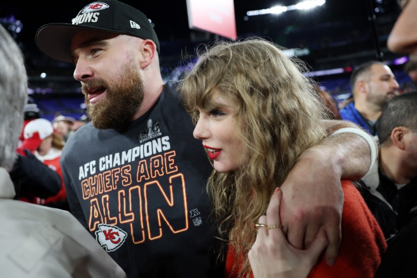 Travis Kelce and Taylor Swift wrap arms after the AFC Championship game against the Ravens.