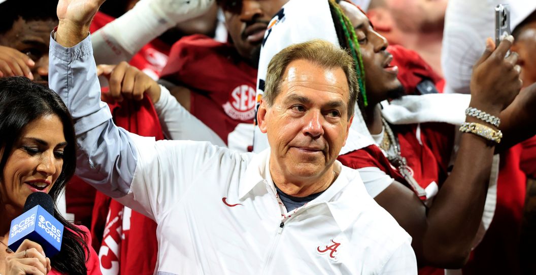 Nick Saban waves his hand in the air.