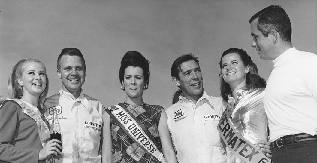 DAYTONA BEACH, FL - FEBRUARY 2, 1969: Drivers Mark Donohue and Chuck Parsons are joined in victory lane by car owner Roger Penske and three of the race queens, including Miss Universe, following their win in the 24 Hours of Daytona at Daytona International Speedway.