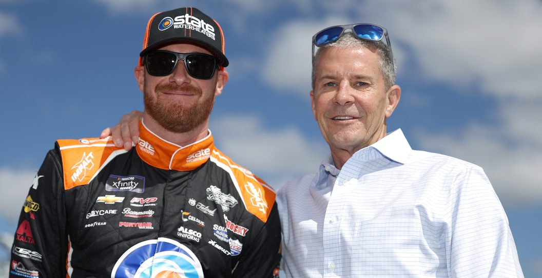 DAYTONA BEACH, FLORIDA - FEBRUARY 18: Jeb Burton, driver of the #27 State Water Heaters Chevrolet, and his father, Ward Burton pose for photos on the grid during qualifying for the Beef. It's What's For Dinner. 300 at Daytona International Speedway on February 18, 2023 in Daytona Beach, Florida.