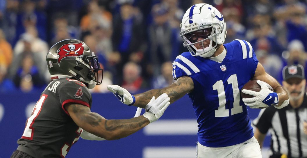 INDIANAPOLIS, INDIANA - NOVEMBER 26: Michael Pittman Jr. #11 of the Indianapolis Colts stiff arms Antoine Winfield Jr. #31 of the Tampa Bay Buccaneers at Lucas Oil Stadium on November 26, 2023 in Indianapolis, Indiana.