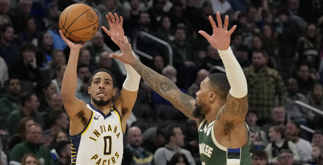 MILWAUKEE, WISCONSIN - JANUARY 01: Tyrese Haliburton #0 of the Indiana Pacers shoots the ball against Damian Lillard #0 of the Milwaukee Bucks during the second half at Fiserv Forum on January 01, 2024 in Milwaukee, Wisconsin. NOTE TO USER: User expressly acknowledges and agrees that, by downloading and or using this photograph, User is consenting to the terms and conditions of the Getty Images License Agreement