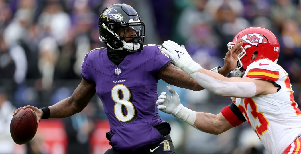 BALTIMORE, MARYLAND - JANUARY 28: Lamar Jackson #8 of the Baltimore Ravens is pressured by Drue Tranquill #23 of the Kansas City Chiefs during the first quarter in the AFC Championship Game at M&T Bank Stadium on January 28, 2024 in Baltimore, Maryland.