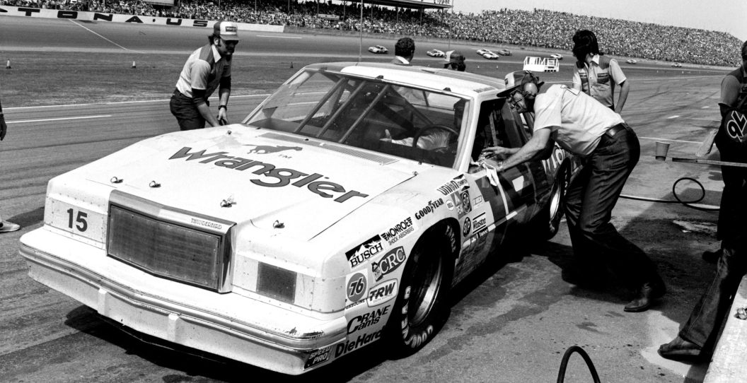 DAYTONA BEACH, FL - JULY 4, 1982: NASCAR car owner Bud Moore talks with his driver, Dale Earnhardt Sr., during a pit stop during the 1982 Firecracker 400 at the Daytona International Speedway on July 4, 1982 in Daytona Beach, Florida.
