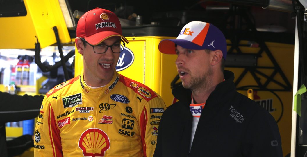 MARTINSVILLE, VIRGINIA - OCTOBER 26: Joey Logano, driver of the #22 Shell Pennzoil Ford, talks with Denny Hamlin, driver of the #11 FedEx Freight Toyota, during practice for the Monster Energy NASCAR Cup Series First Data 500 at Martinsville Speedway on October 26, 2019 in Martinsville, Virginia.