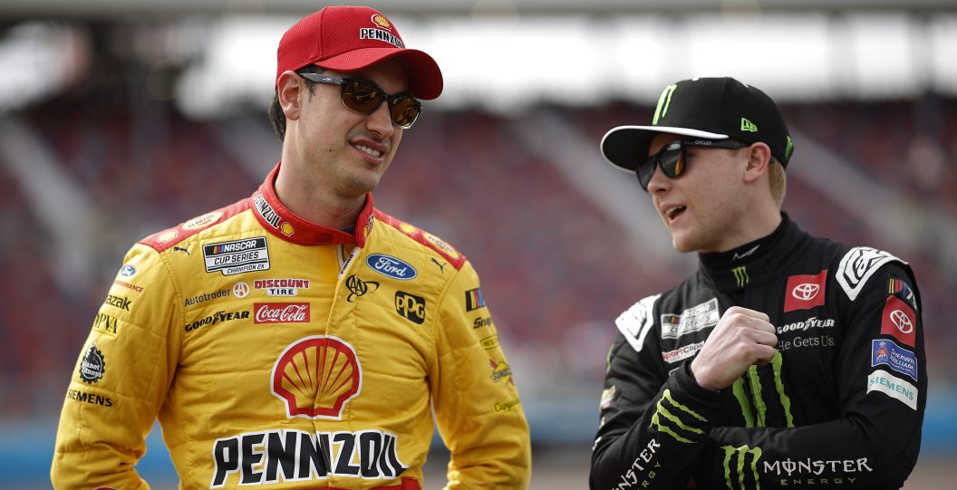 AVONDALE, ARIZONA - MARCH 11: Joey Logano, driver of the #22 Shell Pennzoil Ford, (L) and Ty Gibbs, driver of the #54 Monster Energy Toyota, talk on the grid during qualifying for the NASCAR Cup Series United Rentals Work United 500 at Phoenix Raceway on March 11, 2023 in Avondale, Arizona.