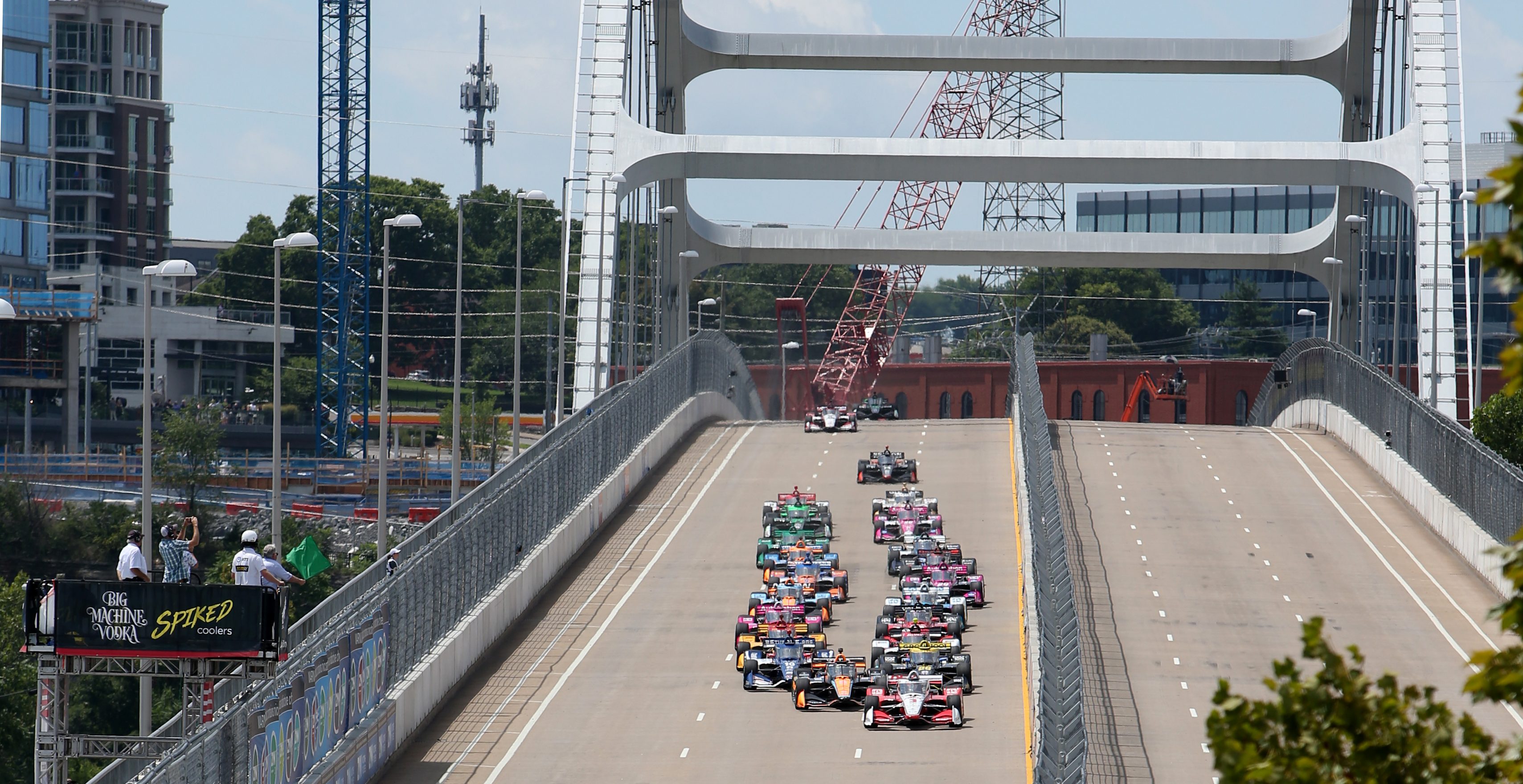 NASHVILLE, TN - AUGUST 06: Cars take the green flag to start the race as they cross over the during Korean War Veterans Memorial Bridge during the INDYCAR Series Music City Grand Prix, August 6, 2023 on a road course in the streets of Nashville, Tennessee.