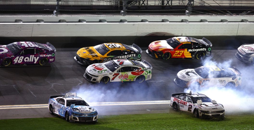DAYTONA BEACH, FLORIDA - FEBRUARY 19: Ross Chastain, driver of the #1 Busch Light Chevrolet, and Austin Cindric, driver of the #2 Discount Tire Ford, spin into the infield grass after an on-track incident during the NASCAR Cup Series Daytona 500 at Daytona International Speedway on February 19, 2024 in Daytona Beach, Florida.