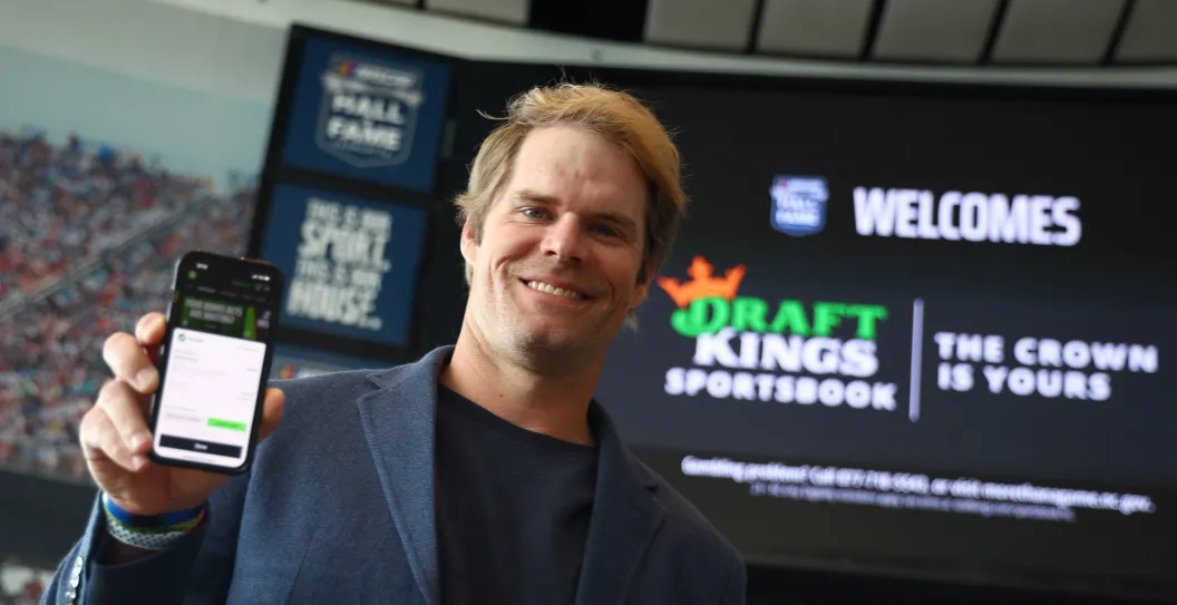 CHARLOTTE, NORTH CAROLINA - MARCH 11: Former NFL tight end and sportscaster Greg Olsen shows the first bet placed during the DraftKings First Bet in North Carolina at NASCAR Hall of Fame on March 11, 2024 in Charlotte, North Carolina.