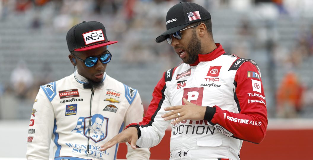 NORTH WILKESBORO, NORTH CAROLINA - MAY 20: Bubba Wallace, driver of the #1 Pristine Auction Toyota, (R) and Rajah Caruth, driver of the #24 Wendell Scott Foundation Chevrolet, talk on the grid during qualifying for the NASCAR Craftsman Truck Series Tyson 250 at North Wilkesboro Speedway on May 20, 2023 in North Wilkesboro, North Carolina.